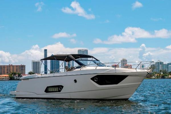 Slide: The Image of 2015 Absolute 40 STL yacht cruising on a sunny day with city skyline backdrop. - 0