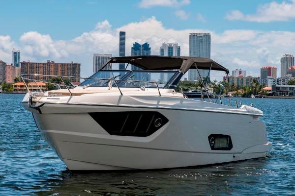 Slide: The Image of 2015 Absolute 40 STL yacht on water with city skyline background. - 2