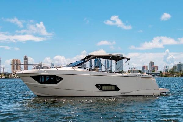 Slide: The Image of 2015 Absolute 40 STL yacht cruising on a sunny day with city skyline in the background. - 3