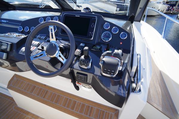 Slide: The Image of Control panel of a 2015 Absolute 40 STL yacht with steering wheel and navigation instruments. - 32