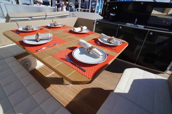 Slide: The Image of Elegant dining setup on 2015 Absolute 40 STL yacht with red placemats and white plates. - 35