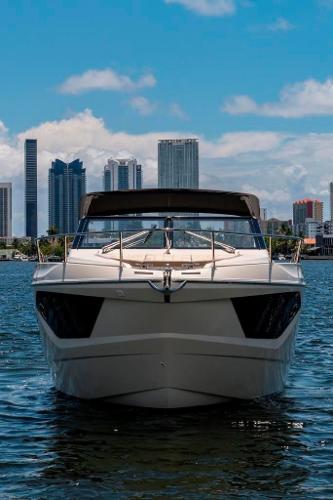 Slide: The Image of 2015 Absolute 40 STL yacht cruising with city skyline backdrop. - 4