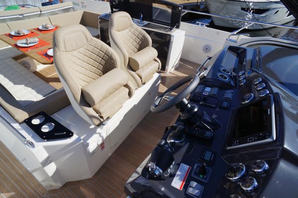 Slide: The Image of 2015 Absolute 40 STL yacht interior with helm, seating, and dining area. - 40