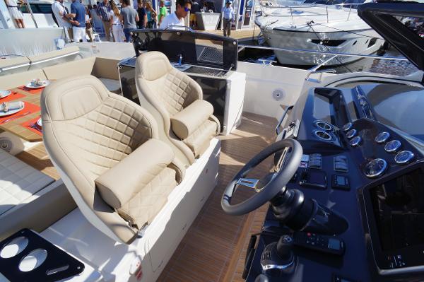 Slide: The Image of Interior of a 2015 Absolute 40 STL yacht with luxurious seating and control panel. - 41