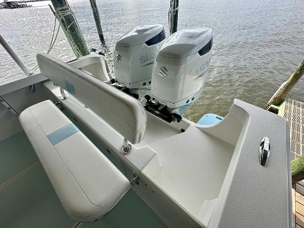 Slide: The Image of 2021 Albury Brothers 27 boat with dual Suzuki outboard engines, docked by the water. - 14