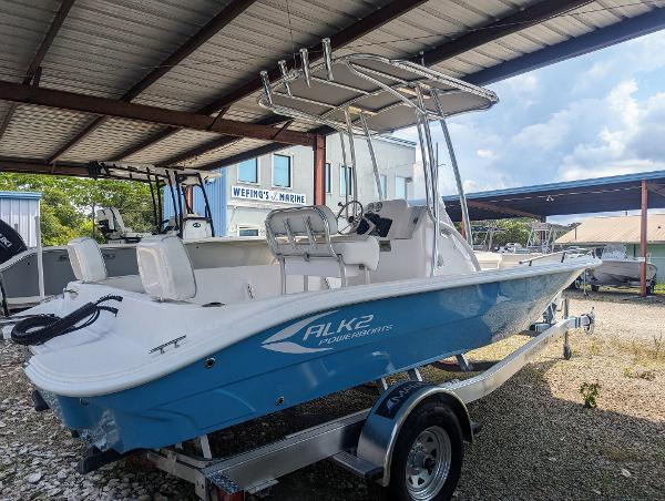 Slide: The Image of 2024 ALK2 Powerboats 22 CRX in blue, parked under a metal canopy. - 10