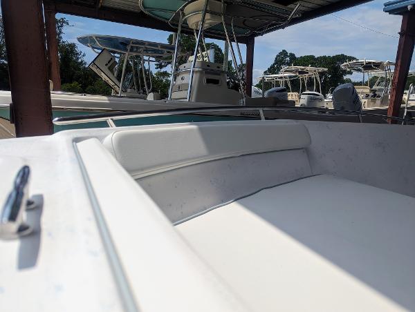 Slide: The Image of 2024 ALK2 Powerboats 22 CRX interior with white seating, docked under a canopy. - 16