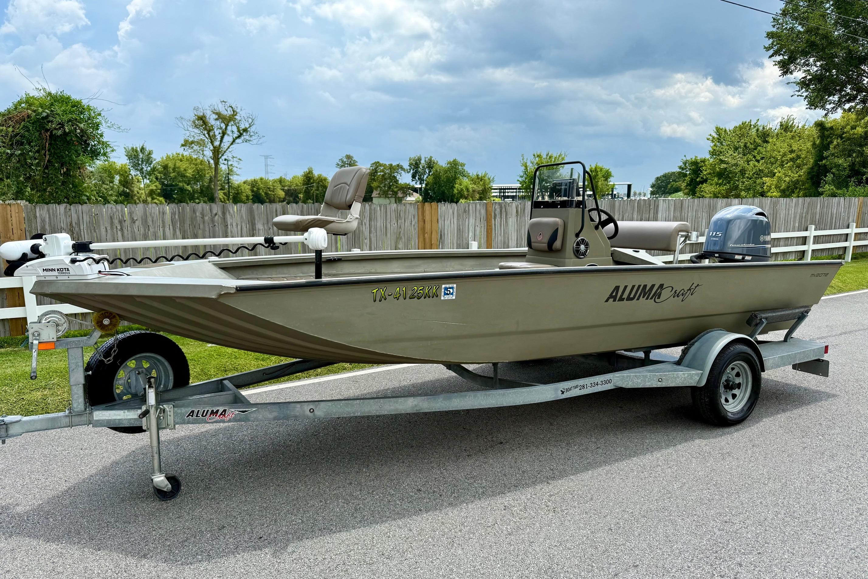 Slide: The Image of 2021 Alumacraft 2072 All Weld MV CC boat on trailer, parked on a road. - 1