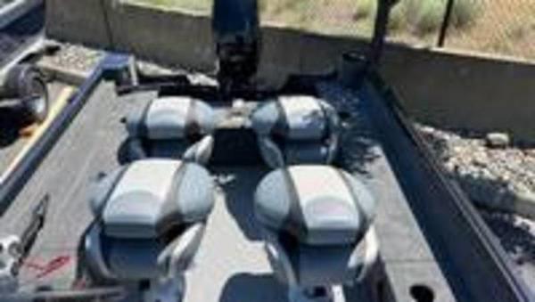 Slide: The Image of 2022 Alumacraft Classic 165 CS boat interior with four seats and motor. - 7
