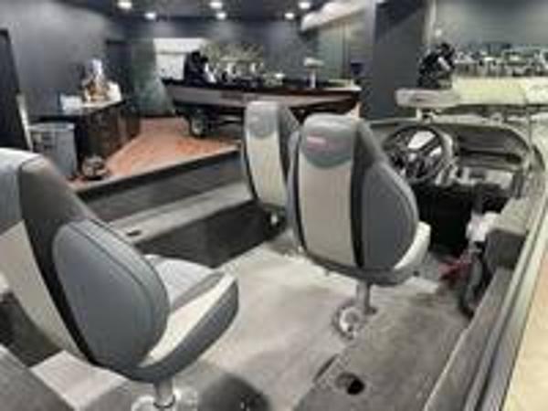 Slide: The Image of 2023 Alumacraft Escape 165 CS boat interior with dual seats and steering console. - 5