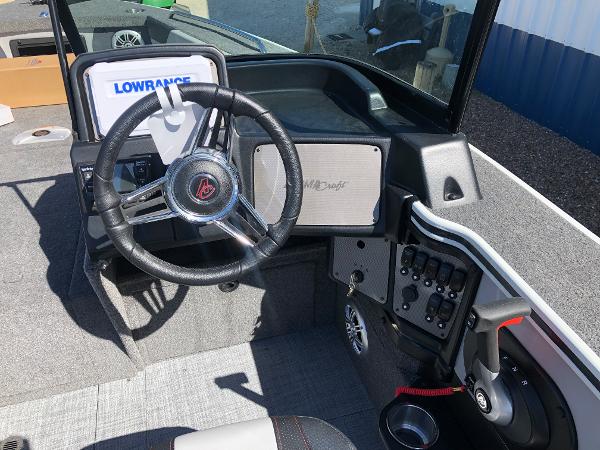 Slide: The Image of 2024 Alumacraft Trophy 195 boat dashboard with Lowrance electronics and steering wheel. - 10