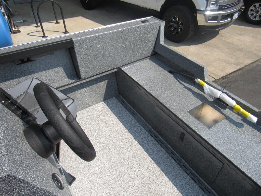 Slide: The Image of Interior of 2024 Alumaweld 20 Adventurer boat with steering wheel and storage compartments. - 10