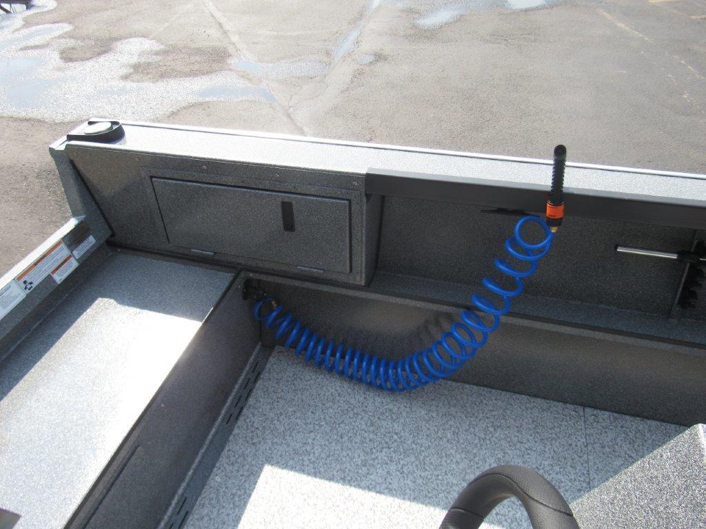 Slide: The Image of 2024 Alumaweld 20 ADVENTURER boat interior with storage compartment and blue coiled hose. - 9