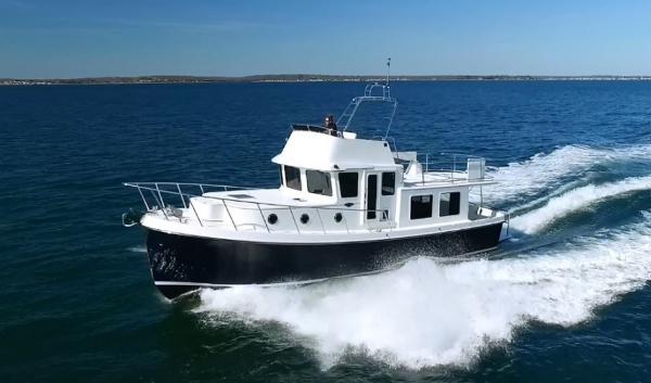 Slide: The Image of 2025 American Tug 395 cruising on open water. - 17