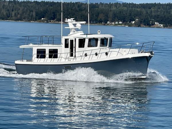 Slide: The Image of 2025 American Tug 395 cruising on a calm lake. - 22