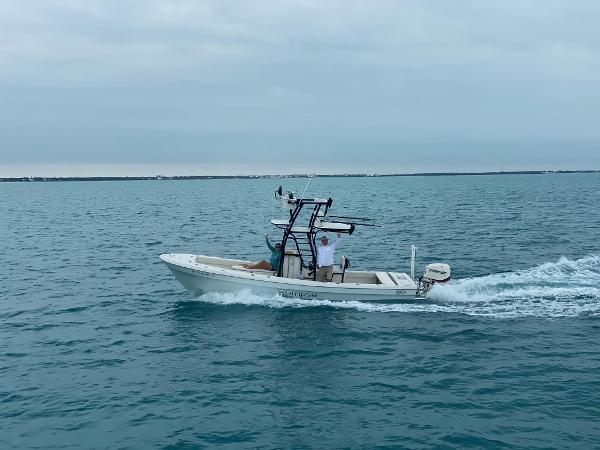 Slide: The Image of 2014 Andros Tarpon 26 boat cruising on open water. - 0