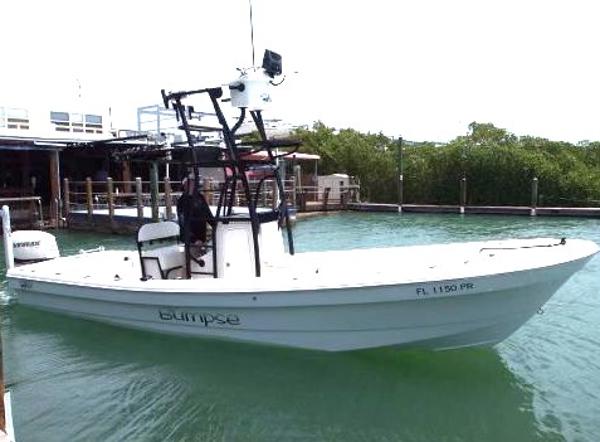 Slide: The Image of 2014 Andros Tarpon 26 boat docked in a marina. - 1