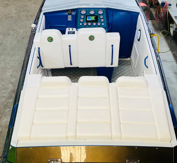 Slide: The Image of 1991 Apache POKER RUN CUSTOM boat interior with white and blue seating. - 11
