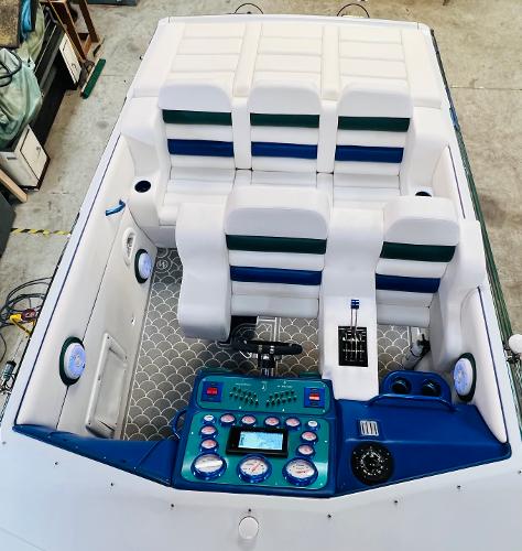 Slide: The Image of 1991 Apache POKER RUN CUSTOM boat interior with white and blue seating. - 22