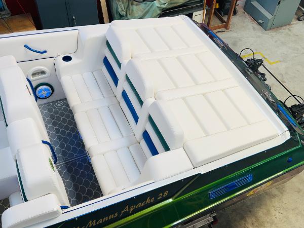 Slide: The Image of 1991 Apache POKER RUN CUSTOM boat with white leather seating and green accents. - 23