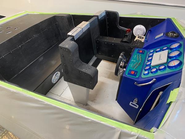 Slide: The Image of 1991 Apache POKER RUN CUSTOM boat interior with blue dashboard and black seating. - 44