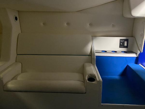Slide: The Image of Interior of 1991 Apache POKER RUN CUSTOM boat with white seating and blue accents. - 7