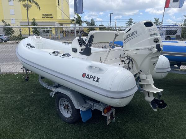 Slide: The Image of White Apex A12 inflatable boat with Suzuki outboard motor on a trailer, 2021 model. - 18