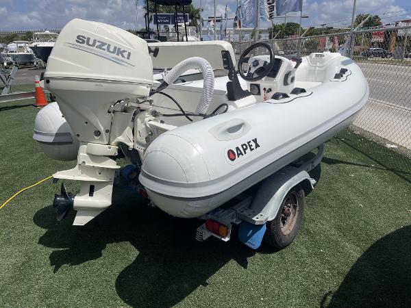 Slide: The Image of Apex A12 inflatable boat with Suzuki outboard motor, 2021 model, on a trailer. - 7