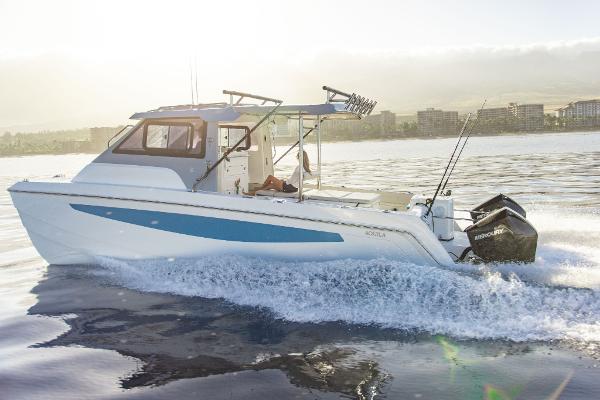 Slide: The Image of 2023 Aquila 28 Molokai Cuddy cruising on water with twin outboard engines. - 7