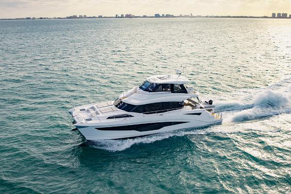 Slide: The Image of 2023 Aquila 70 Luxury yacht cruising on open water. - 0
