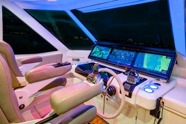 Slide: The Image of Cockpit of 2023 Aquila 70 Luxury yacht with advanced navigation systems and dual captain chairs. - 11