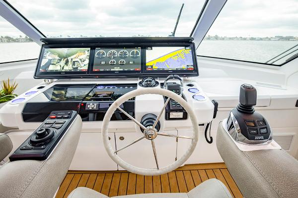 Slide: The Image of 2023 Aquila 70 Luxury yacht helm with advanced navigation systems and controls. - 12