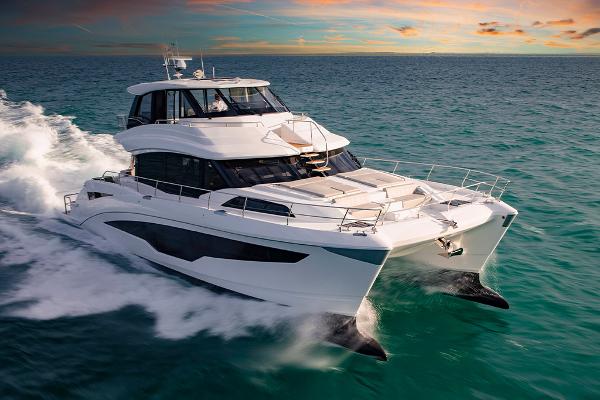 Slide: The Image of 2023 Aquila 70 Luxury yacht cruising at sunset. - 2