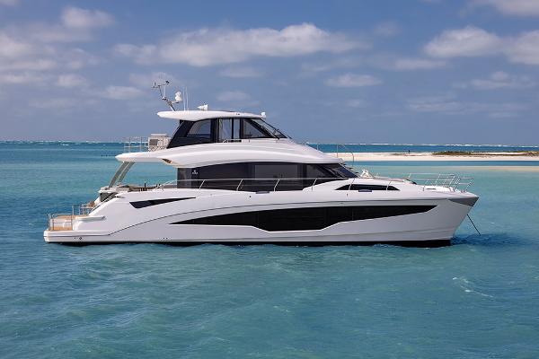 Slide: The Image of 2023 Aquila 70 Luxury yacht cruising in clear blue waters. - 3