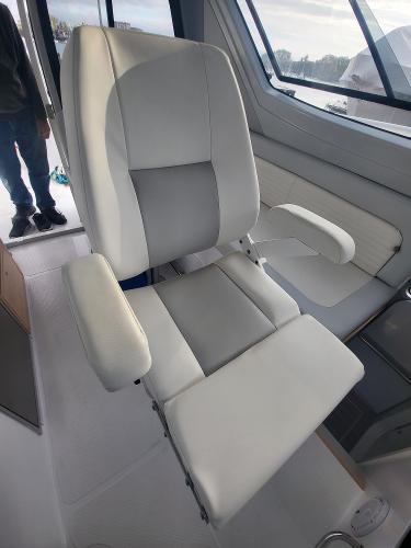 Slide: The Image of 2024 ArrowCat 320 boat interior with a comfortable captain's chair. - 1