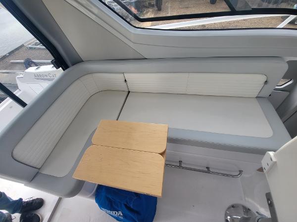 Slide: The Image of 2024 ArrowCat 320 interior seating area with a small wooden table. - 5