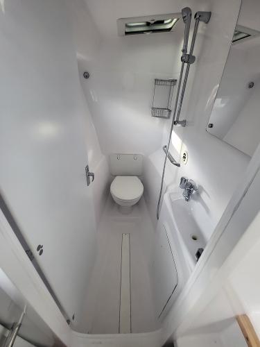 Slide: The Image of 2024 ArrowCat 320 boat bathroom with shower, toilet, and sink. - 9