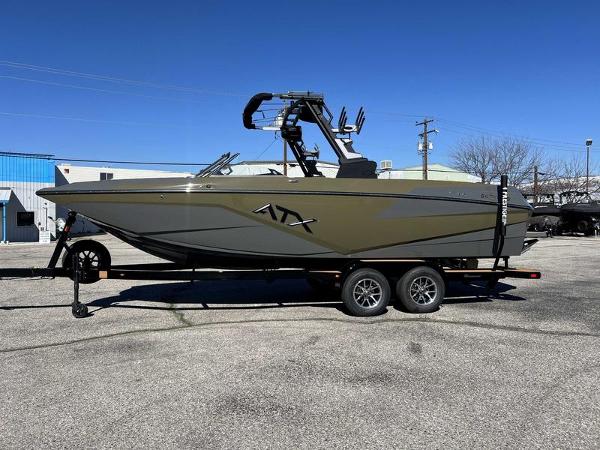 Slide: The Image of 2024 ATX Surf Boats 24 Type-S on a trailer in a parking lot. - 0