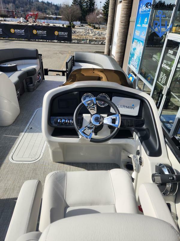 Slide: The Image of 2023 Avalon 2585 Catalina Entertainer boat interior with steering wheel and Garmin navigation system. - 14