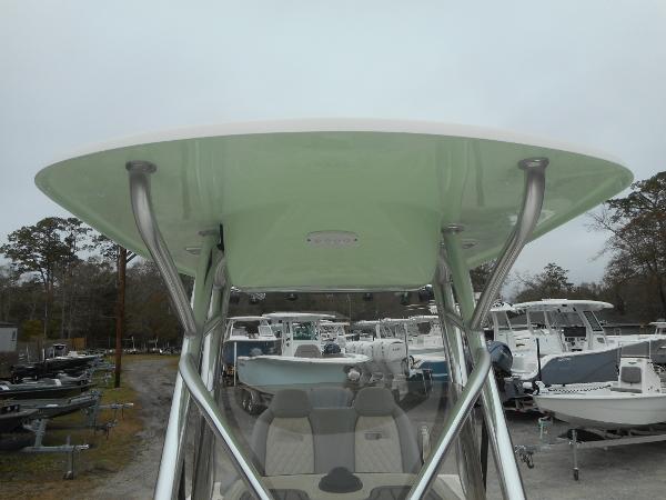 Slide: The Image of 2024 Avenger 26 Avenger boat with T-top in a marina. - 14