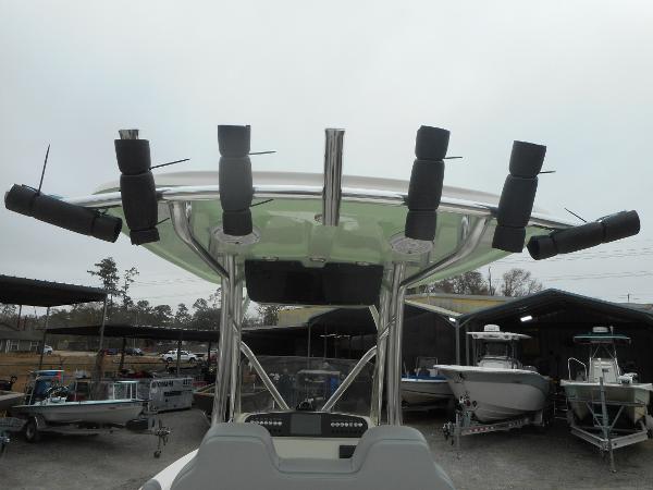 Slide: The Image of 2024 Avenger 26 Avenger boat with rod holders and canopy in a marina. - 15