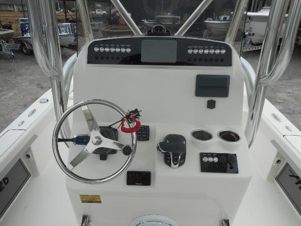 Slide: The Image of 2024 Avenger 26 Avenger boat console with steering wheel and controls. - 4