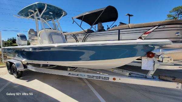 Slide: The Image of 2024 Avenger AV26 boat on a trailer in a marina. - 1