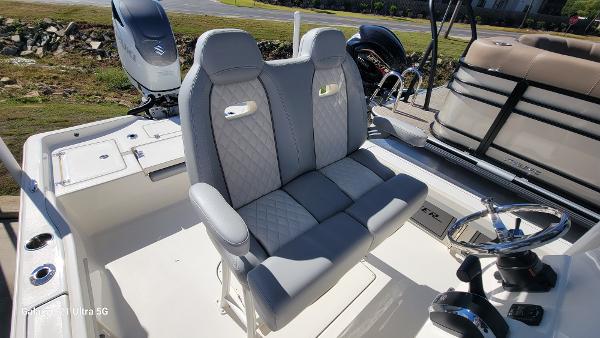 Slide: The Image of 2024 Avenger AV26 boat with dual captain's chairs and steering console. - 16