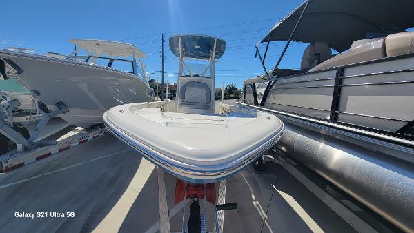 Slide: The Image of 2024 Avenger AV26 boat on display between other boats under clear blue sky. - 2