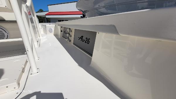 Slide: The Image of 2024 Avenger AV26 boat deck with white finish and storage compartments. - 21