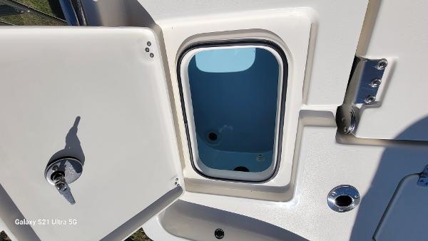 Slide: The Image of Open storage compartment on a 2024 Avenger AV26 boat. - 22