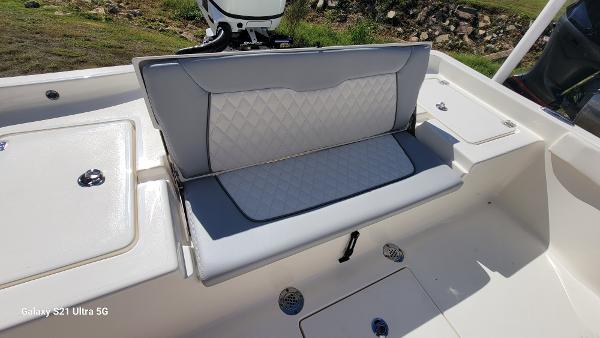 Slide: The Image of 2024 Avenger AV26 boat with cushioned seating and storage compartments. - 24