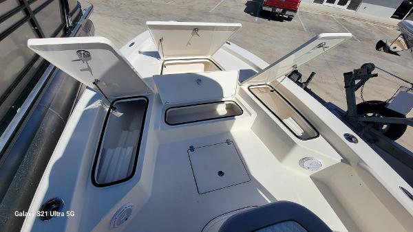 Slide: The Image of 2024 Avenger AV26 boat with open storage compartments on deck. - 7
