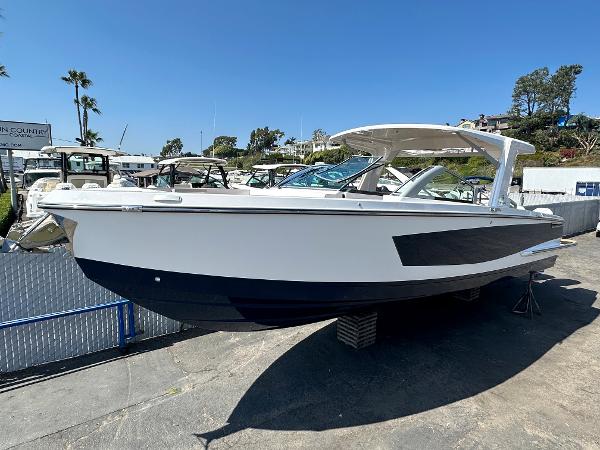 Slide: The Image of 2024 Aviara AV36 boat displayed on a stand in a marina. - 0